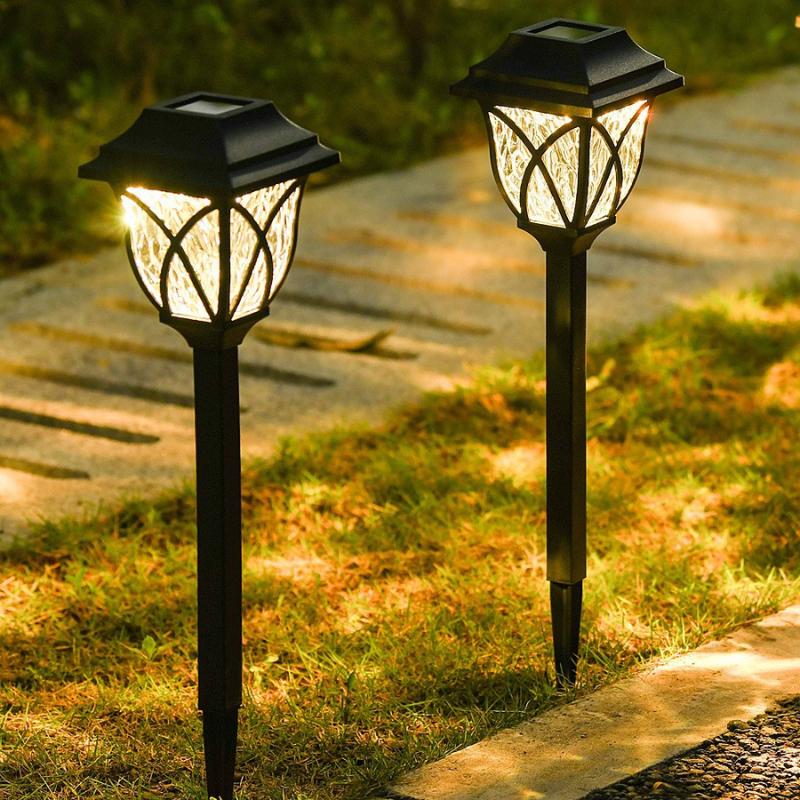 Two Outdoor Solar Garden Path Lights on a grassy path with a blurred background
